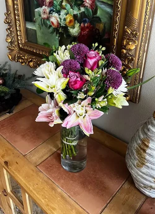 Purple, white, and pink bouquet in a vase